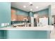 Open-concept kitchen with breakfast bar, wood cabinets, and modern appliances at 1028 S Valle Verde --, Mesa, AZ 85208