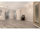 Spacious living area featuring gray wood flooring and neutral paint throughout at 1028 S Valle Verde --, Mesa, AZ 85208