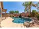 Inviting pool with rock features surrounded by lush greenery, perfect for relaxation and summer fun at 1028 S Valle Verde --, Mesa, AZ 85208