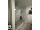 Shower showcasing tiled walls and flooring inside a glass enclosure and shower head at 12421 N 41St Pl, Phoenix, AZ 85032