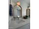 Bright bathroom featuring wood-trimmed mirrors, stylish lighting, and a modern countertop with a rectangular sink at 12421 N 41St Pl, Phoenix, AZ 85032