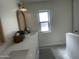 Well-lit bathroom with dual wood-trimmed mirrors, a bright window, and ample countertop space with modern fixtures at 12421 N 41St Pl, Phoenix, AZ 85032
