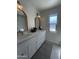 Stylish bathroom featuring dual vanities, elegant mirrors, modern fixtures, and ample natural light at 12421 N 41St Pl, Phoenix, AZ 85032
