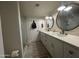 Bright bathroom showcasing double vanity, round mirrors, glass enclosed shower, and neutral tile floors at 12421 N 41St Pl, Phoenix, AZ 85032