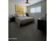 Bright bedroom features a bed, stylish decor, neutral walls, and a ceiling fan, creating a serene atmosphere at 12421 N 41St Pl, Phoenix, AZ 85032