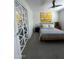 Modern bedroom with stylish décor, a comfortable bed, unique closet doors, and a ceiling fan at 12421 N 41St Pl, Phoenix, AZ 85032
