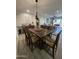 Spacious dining room area leading to an open-concept living space and outdoor patio at 12421 N 41St Pl, Phoenix, AZ 85032