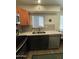 Well-lit kitchen featuring stainless steel appliances, wood flooring, and modern finishes at 12421 N 41St Pl, Phoenix, AZ 85032