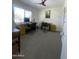 Spacious home office featuring dual workstations, a ceiling fan, and ample natural light, ideal for productivity at 12421 N 41St Pl, Phoenix, AZ 85032