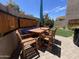 Inviting outdoor patio with wood furniture, blue cushions, and a well-manicured lawn at 12421 N 41St Pl, Phoenix, AZ 85032