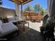 Covered outdoor patio featuring comfortable lounge seating and an adjacent dining area at 12421 N 41St Pl, Phoenix, AZ 85032