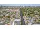 Comprehensive aerial view of a neighborhood with a long road, golf course, buildings, and commercial properties at 1274 E Edgemont Ave, Phoenix, AZ 85006
