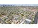 Panoramic aerial view of a residential area with winding streets, lush greenery, and a cityscape backdrop at 1274 E Edgemont Ave, Phoenix, AZ 85006