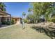 Spacious backyard with a lush lawn, mature trees, and a patio area ideal for outdoor enjoyment at 1274 E Edgemont Ave, Phoenix, AZ 85006
