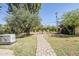 Green backyard features mature landscaping, brick pathways, and a white generator at 1274 E Edgemont Ave, Phoenix, AZ 85006