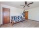 Inviting bedroom with a comfy futon, ceiling fan, and warm-toned walls at 1274 E Edgemont Ave, Phoenix, AZ 85006