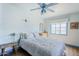 Bright bedroom features a blue ceiling fan, hardwood floors, and plenty of natural light at 1274 E Edgemont Ave, Phoenix, AZ 85006