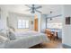 Bright bedroom features a blue ceiling fan, hardwood floors, and plenty of natural light at 1274 E Edgemont Ave, Phoenix, AZ 85006