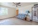 Cozy bedroom featuring a futon, ceiling fan, and light wood-look flooring at 1274 E Edgemont Ave, Phoenix, AZ 85006