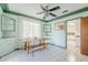 Charming dining room features a wooden table, bench, tile floors and a vintage ceiling fan at 1274 E Edgemont Ave, Phoenix, AZ 85006