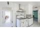 Kitchen boasts vintage range hood, checkerboard backsplash, and access to other rooms at 1274 E Edgemont Ave, Phoenix, AZ 85006
