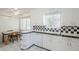 Kitchen boasts tiled countertops and backsplash, bright white cabinets and a breakfast nook at 1274 E Edgemont Ave, Phoenix, AZ 85006