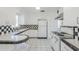 Bright kitchen with tiled backsplash, white appliances, and plentiful cabinet space at 1274 E Edgemont Ave, Phoenix, AZ 85006