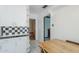 A kitchen featuring white cabinets with black and white checkered tiles at 1274 E Edgemont Ave, Phoenix, AZ 85006
