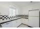 The kitchen offers classic black and white tiles, ample counter space, and plenty of cabinets at 1274 E Edgemont Ave, Phoenix, AZ 85006