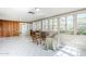 Bright living room with tile floors, wood-paneled wall, and light from surrounding windows at 1274 E Edgemont Ave, Phoenix, AZ 85006