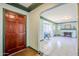 Bright living room with white tile floors, a decorative fireplace, and an arched doorway at 1274 E Edgemont Ave, Phoenix, AZ 85006
