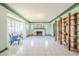 Spacious living room with large windows, white tile flooring, and a decorative fireplace at 1274 E Edgemont Ave, Phoenix, AZ 85006