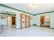 Expansive living room featuring white tile, and custom shelving at 1274 E Edgemont Ave, Phoenix, AZ 85006