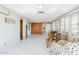 Light-filled living room with white tile, wood-paneled wall, and vintage brick details at 1274 E Edgemont Ave, Phoenix, AZ 85006
