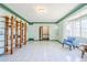 Spacious open living room with white tile, custom shelving, and decorative trim at 1274 E Edgemont Ave, Phoenix, AZ 85006