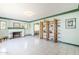 Open living room with white tile floors, fireplace, and custom shelving at 1274 E Edgemont Ave, Phoenix, AZ 85006