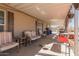 Covered back porch with outdoor seating and a grill at 1347 S Oak Rd, Maricopa, AZ 85139