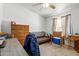 Bedroom with a dresser, couch, and a window to let the sun in at 1347 S Oak Rd, Maricopa, AZ 85139