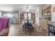 Open dining room with wood floors and a view into the kitchen, ideal for Gathering meals and entertaining at 1347 S Oak Rd, Maricopa, AZ 85139