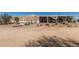 Exterior shot of the home with a porch and desert landscaping at 1347 S Oak Rd, Maricopa, AZ 85139