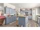 Large kitchen with ample storage space, blue cabinets and center island, perfect for cooking at 1347 S Oak Rd, Maricopa, AZ 85139