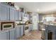 Well-equipped kitchen boasting blue cabinets, modern appliances, and a functional layout at 1347 S Oak Rd, Maricopa, AZ 85139