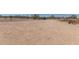 Large dirt lot featuring desert vegetation and mountain views, perfect for building your dream home at 1347 S Oak Rd, Maricopa, AZ 85139