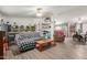 Spacious living room featuring hardwood floors, ceiling fan, and dining area at 1347 S Oak Rd, Maricopa, AZ 85139
