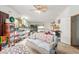 Living room with a couch, shelving units, and fish tanks at 1347 S Oak Rd, Maricopa, AZ 85139