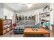 Living room features an aquarium, shelving, and ceiling fan at 1347 S Oak Rd, Maricopa, AZ 85139