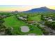 Expansive aerial view of the golf course and mountain backdrop at sunset at 1637 N Quartz Valley Rd, Scottsdale, AZ 85266