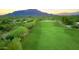 Aerial view of the golf course with mountain views in the background at 1637 N Quartz Valley Rd, Scottsdale, AZ 85266