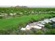 Aerial view of home situated next to the golf course in a green desert community at 1637 N Quartz Valley Rd, Scottsdale, AZ 85266