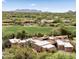 Aerial view of a home featuring a golf course view, a tile roof, desert landscaping, and surrounding mountains at 1637 N Quartz Valley Rd, Scottsdale, AZ 85266